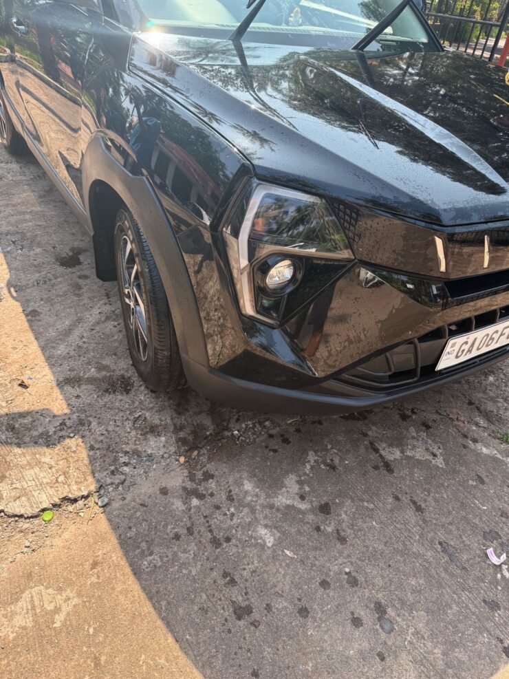 Freshly washed black SUV with water droplets reflecting sunlight at Lawrence Service Station, Goa.
